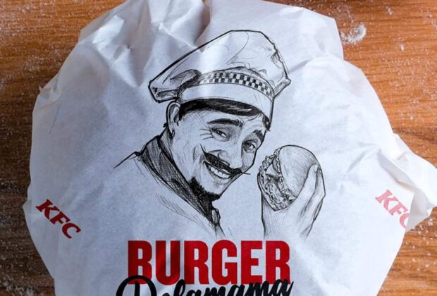 Burger Delamama KFC emballé dans un papier illustré